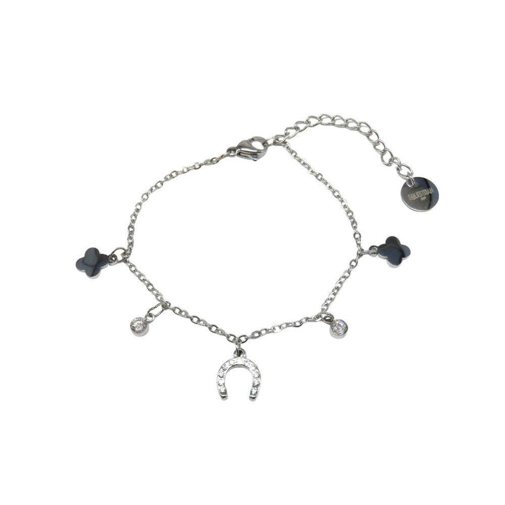 The Ziggy Bracelet features a delicate silver chain with a horseshoe charm, two black four-leaf clover charms, two sparkling crystals, and an adjustable clasp with a circular tag.
