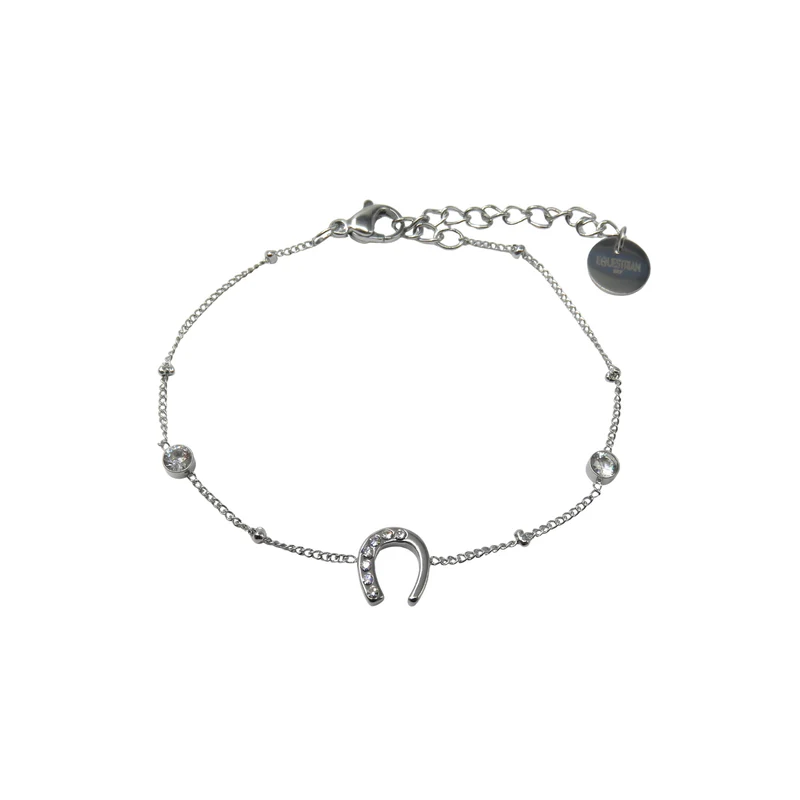 Willow Bracelet: A delicate silver chain with a crystal-studded horseshoe charm, two round crystal accents, and an adjustable clasp with a round tag.