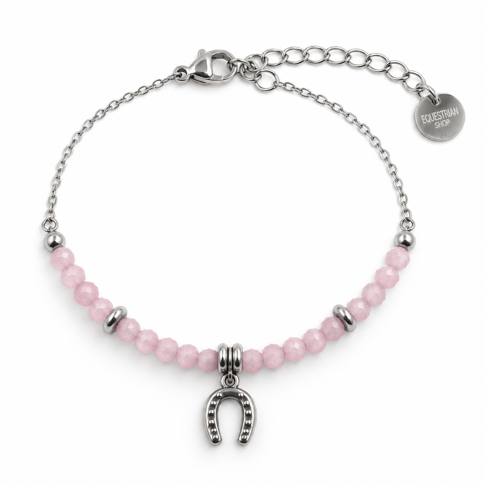 Silver chain bracelet with pink faceted beads, a horseshoe charm, and a circular tag that reads Equestrian Shop.
